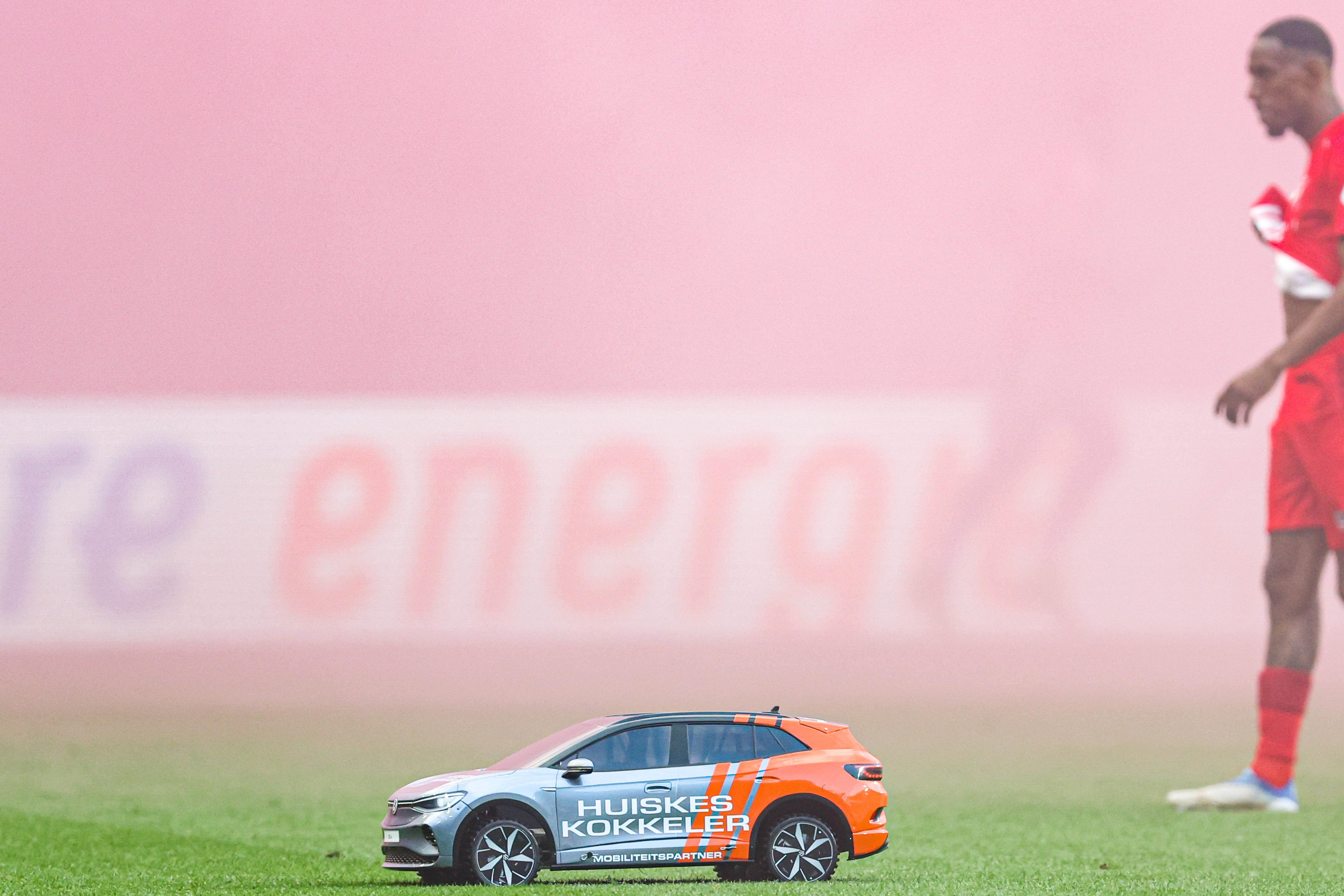 Een auto van Huiskes-Kokkeler op het veld bij FC Twente