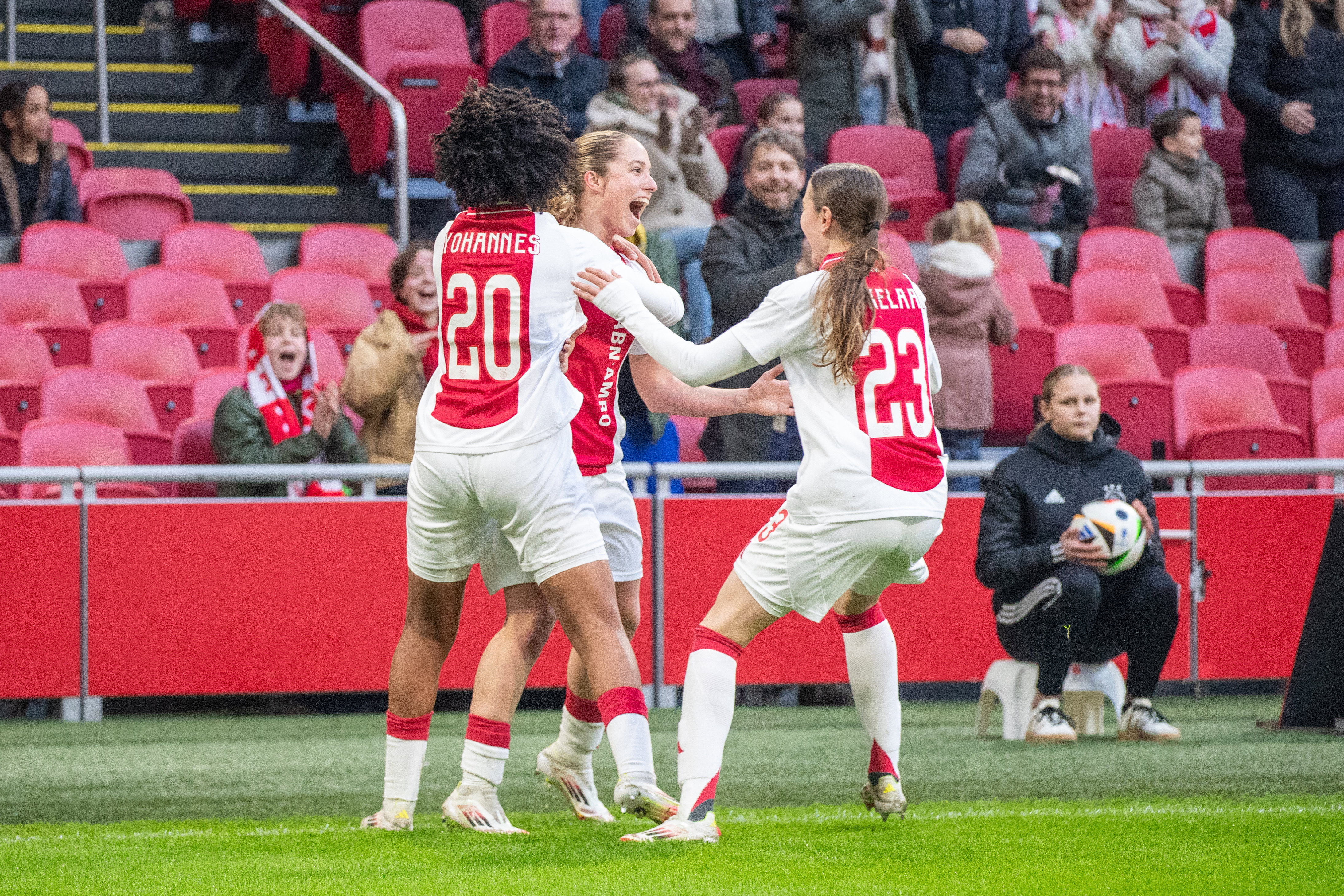 Lily Yohannes, Danique Tolhoek en Lotte Keukelaar juichen na een goal van Ajax
