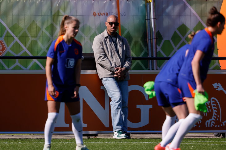Nigel de Jong kijkt naar een training van de OranjeLeeuwinnen