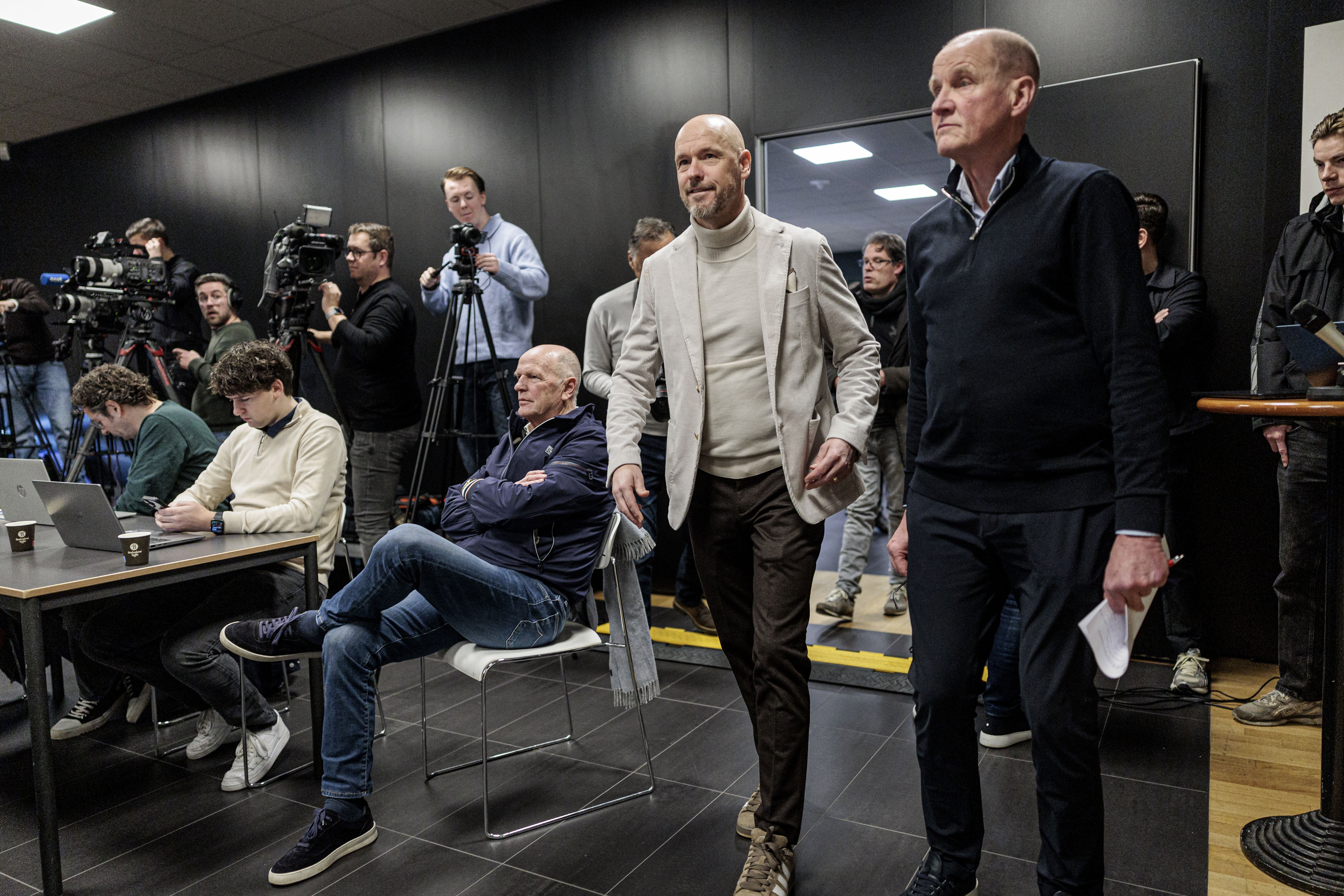 Erik ten Hag komt de perszaal binnen, Jan Streuer kijkt toe