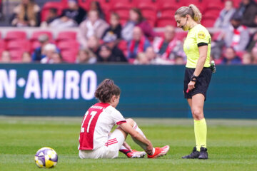 Nurija van Schoonhoven zit op het gras van de Johan Cruijff ArenA