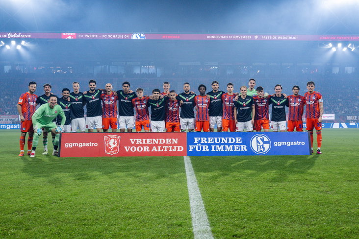 Spelers van FC Twente en Schalke 04 poseren vlak voor de jubileumwedstrijd
